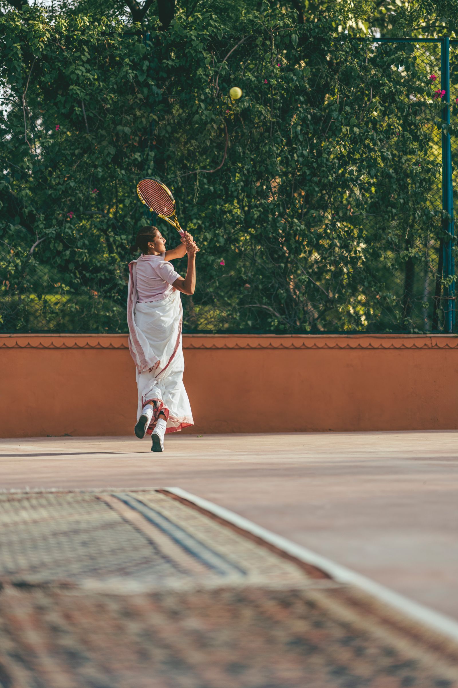 Image may contain Adult Person Racket Sport Tennis Tennis Racket Ball Tennis Ball Clothing Footwear and Shoe