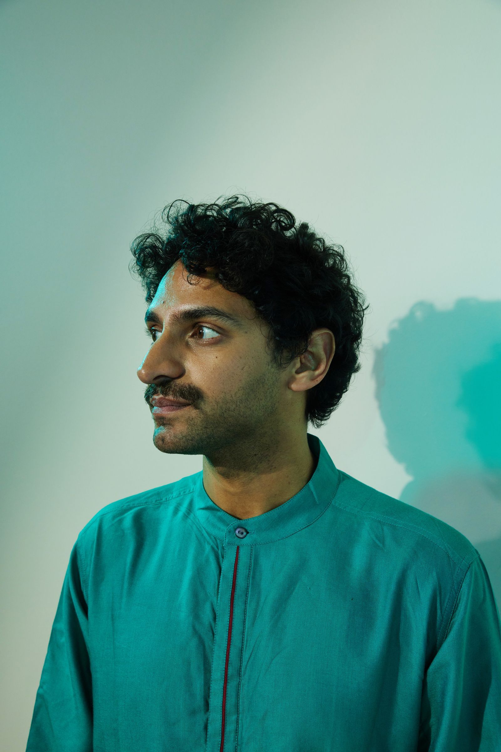 Image may contain Karan Soni Adult Person Head Face Black Hair Hair Body Part Neck Photography and Portrait