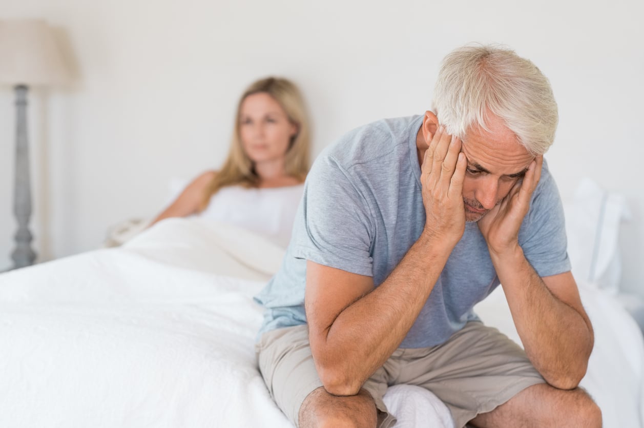 Couple in bed with issue with sexual health
