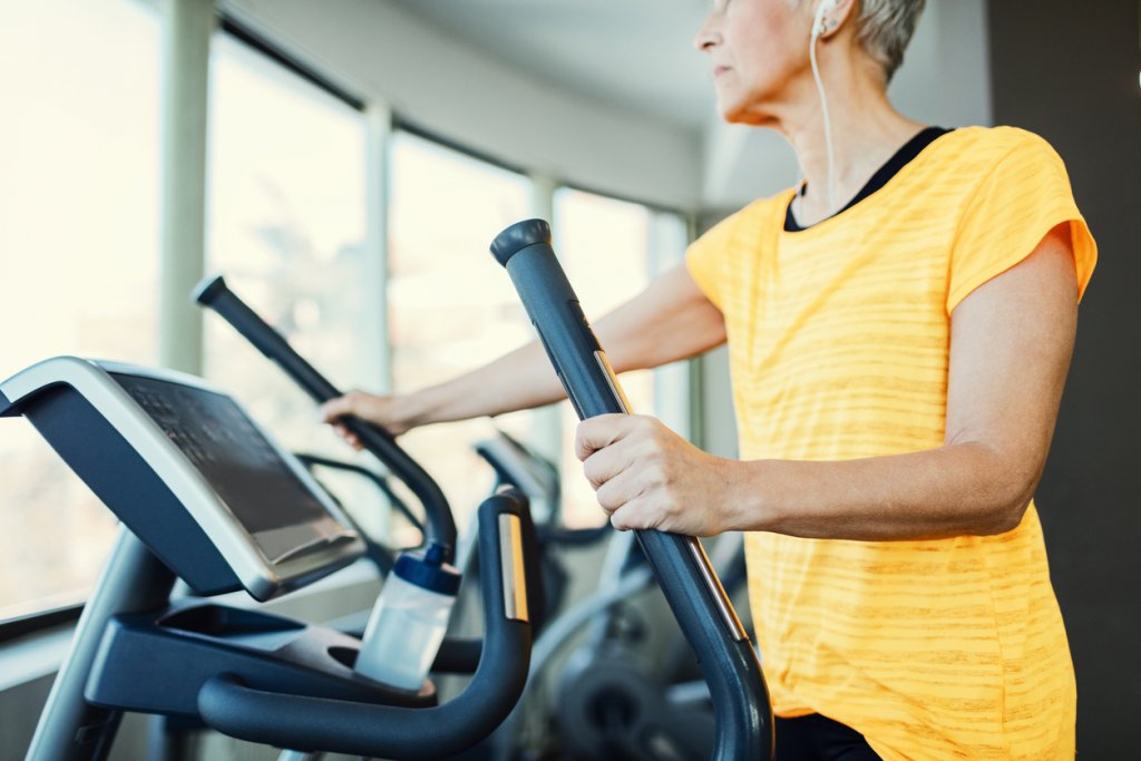 What Are the Best HIIT Workouts for Women Over 50? 5 Woman On Elliptical
