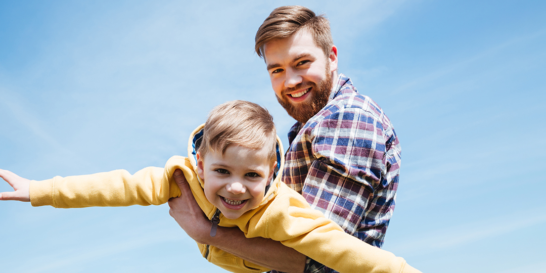 father his little son playing together park