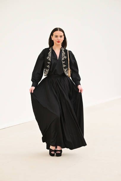 Image may contain Adult Person Clothing Dress Fashion Long Sleeve Sleeve Coat Formal Wear and Gown