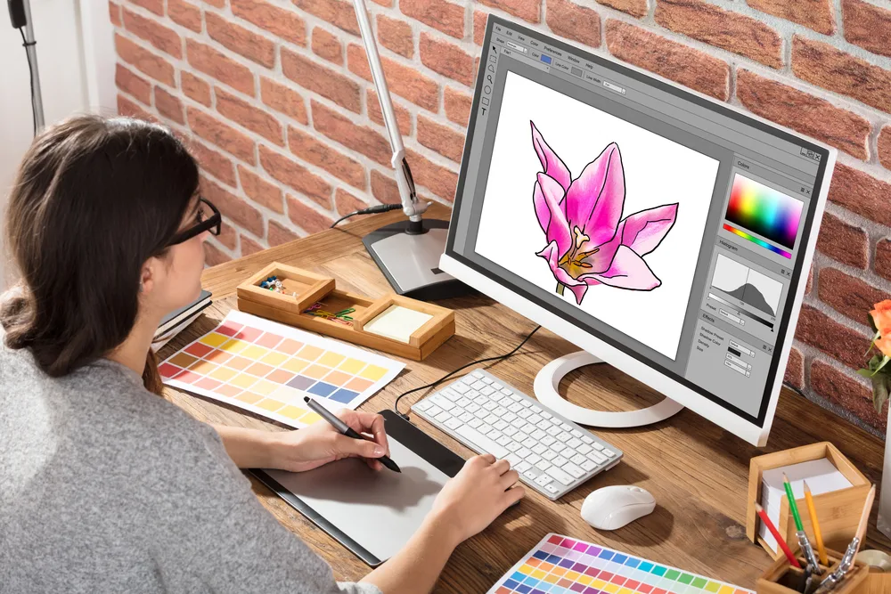 A female graphic designer using Photoshop to create digital designs