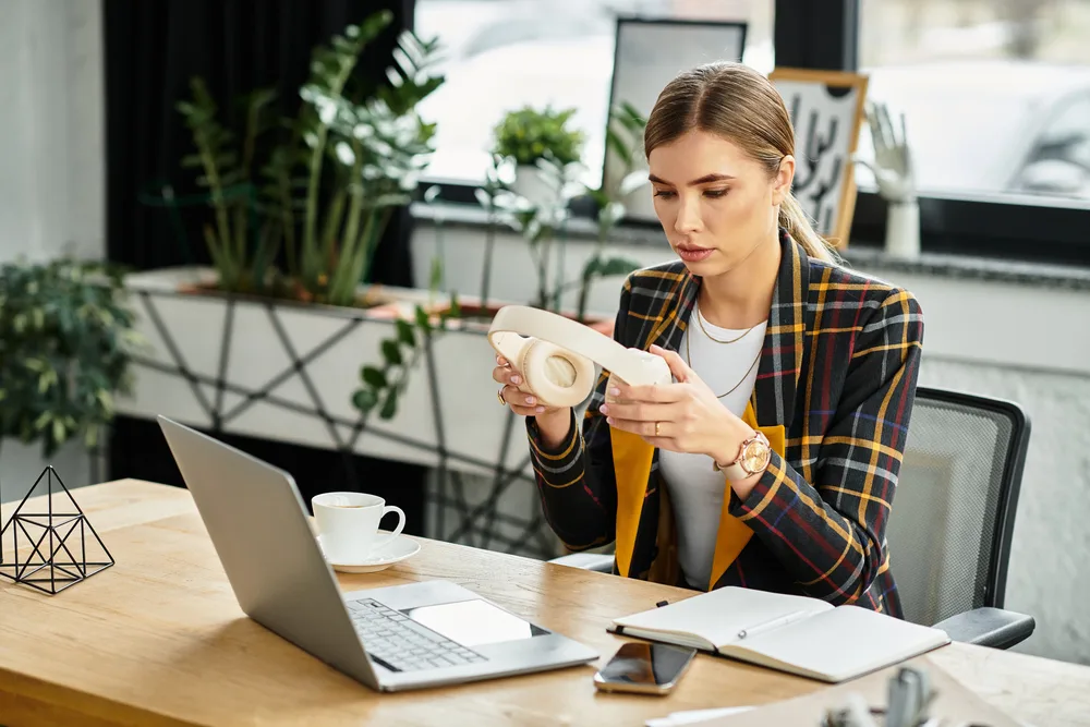 A young woman putting on headphones getting ready to write a resume