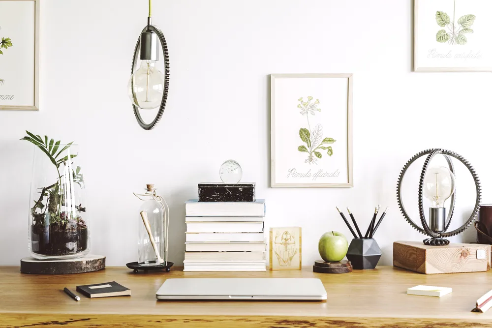 Modern home office interior with wooden desk books laptop and more